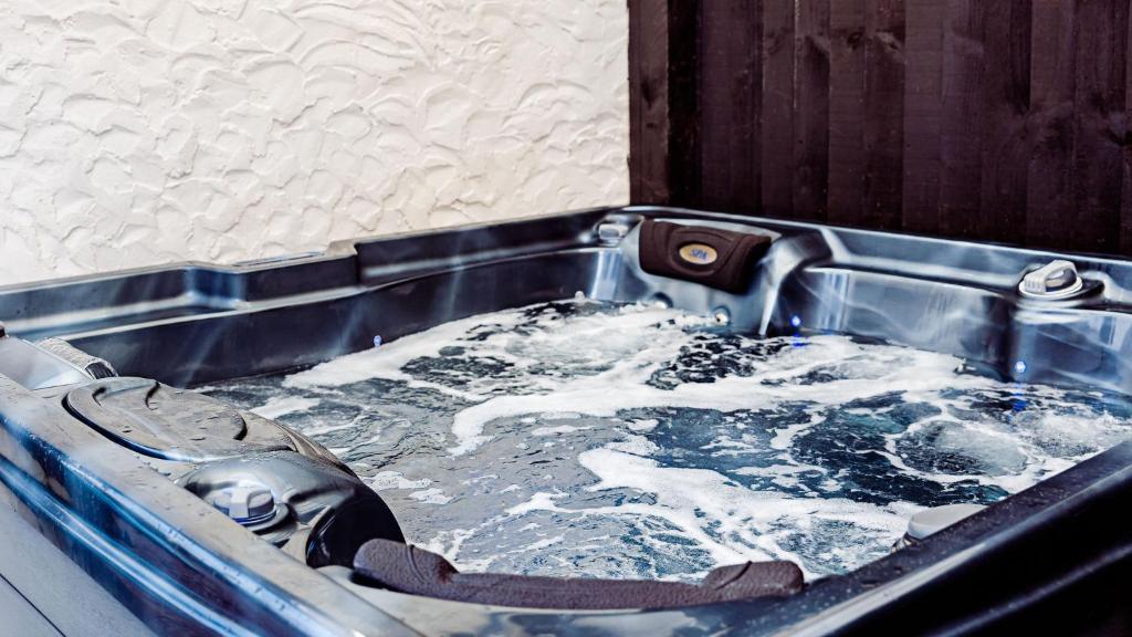 a bath tub filled with water in a sink at Willow Chalet near Cartmel & Lake Windermere in Flookburgh
