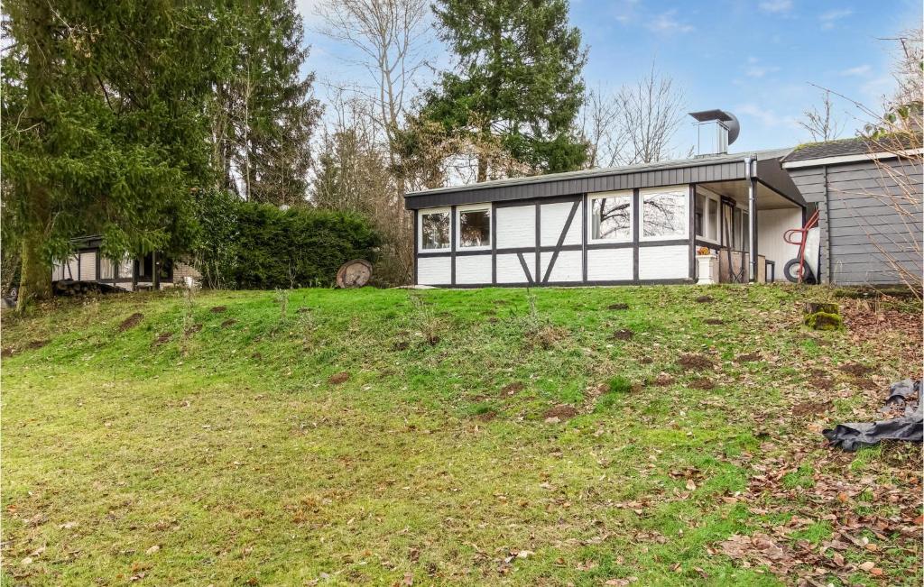 a house on a grassy hill with a house at Ferienhaus Schne Aussicht in Gerolstein