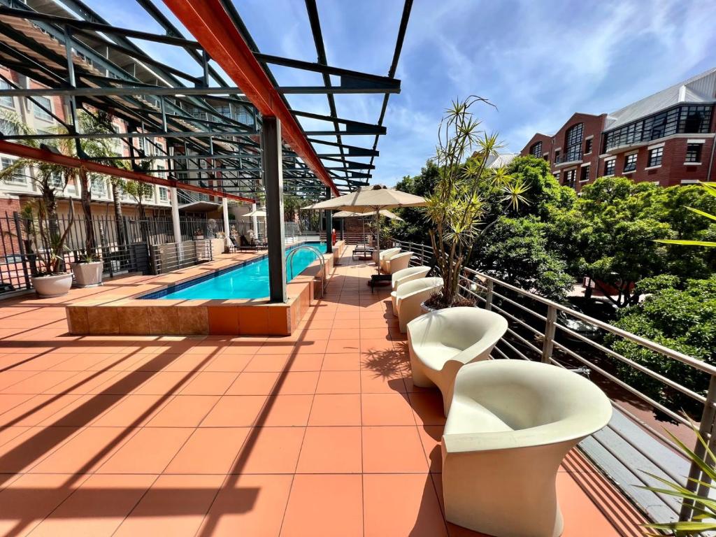 a pool on the roof of a building at No load-shedding Spacious Apartment in Cape Town