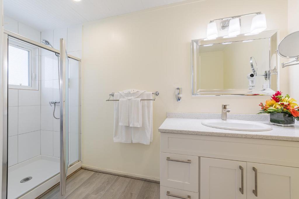 a white bathroom with a sink and a shower at La Vista Resort in Simpson Bay