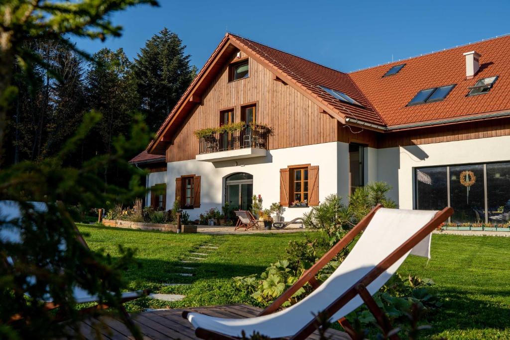 a house with a chair in front of it at Zagroda na Pacanach in Iwkowa