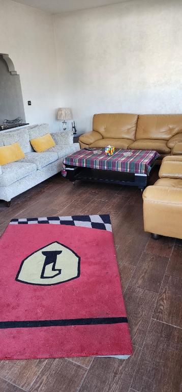a living room with a couch and a red rug at residence baida in Casablanca