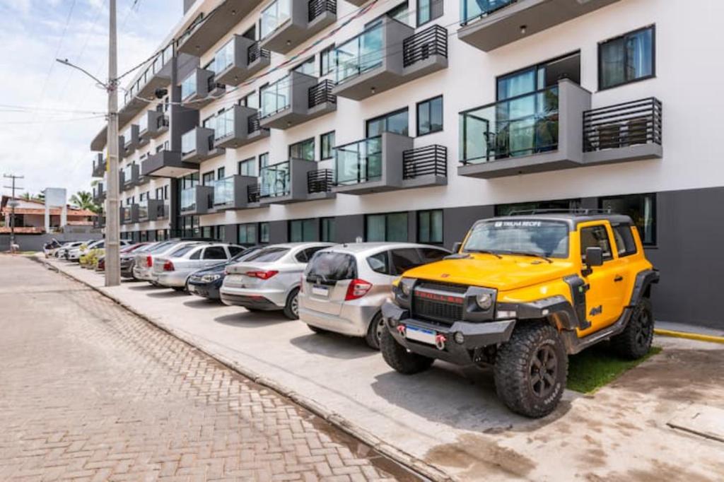 a yellow jeep parked in front of a building at Maracaipe, um paraíso para você - Maraca Beach Residence II - ap 111 in Ipojuca