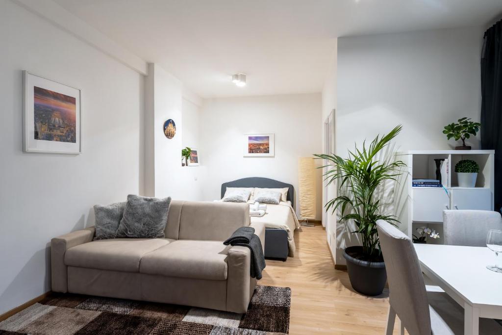 un soggiorno con divano e letto di Suite 1,2 porta Milano centro parking free a Milano