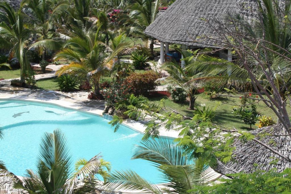 an overhead view of a resort pool with palm trees at Baobab Village in Watamu