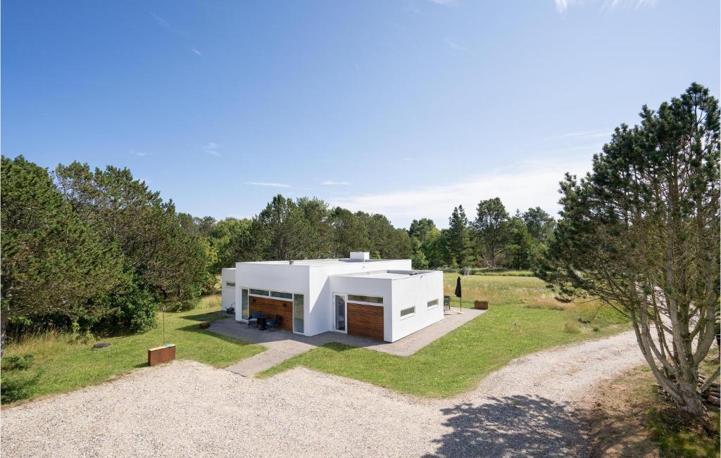 a modern house in the middle of a field at Amazing Home In lbk With 3 Bedrooms And Wifi in Ålbæk