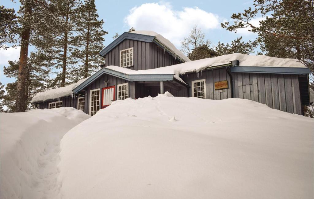 a pile of snow in front of a house at Nice Home In Noresund With 5 Bedrooms And Sauna in Noresund