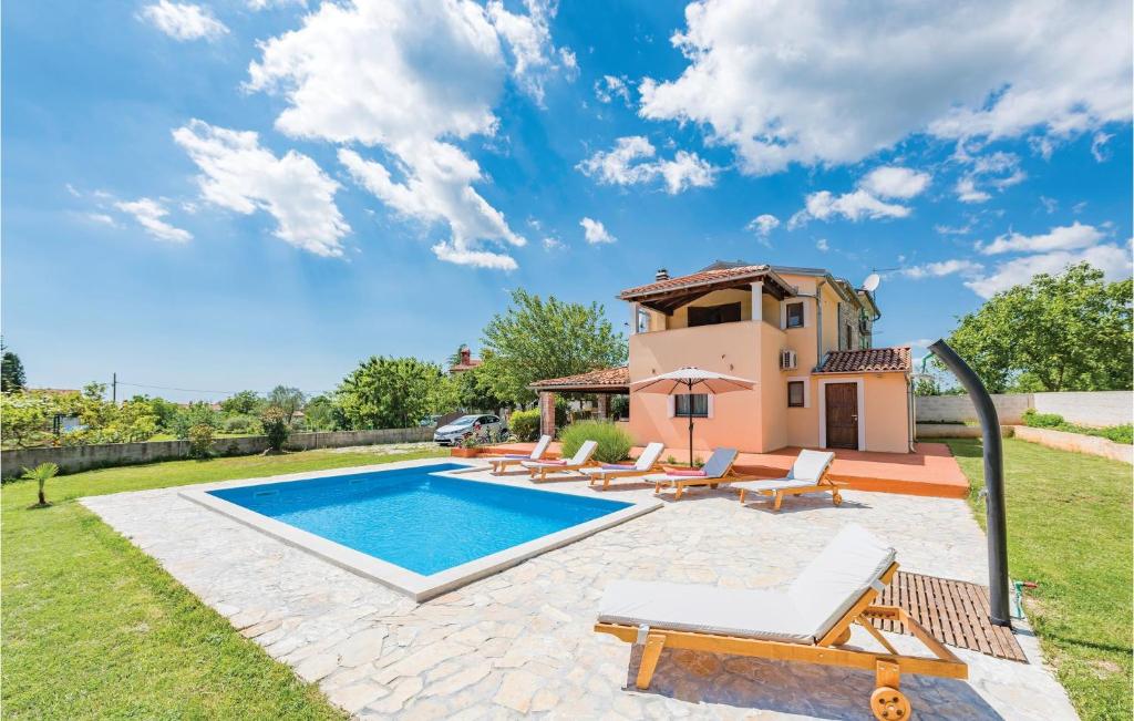 a villa with a swimming pool and a house at Stunning Home In Peresiji With Kitchen in Peresiji