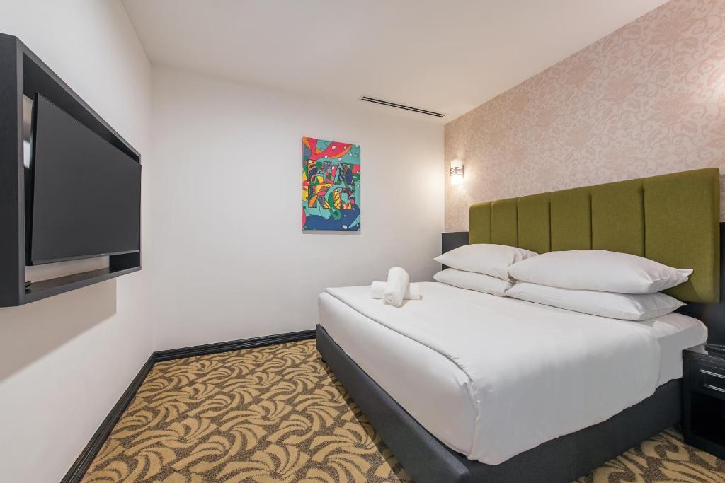 Postel nebo postele na pokoji v ubytování HAKO HOTEL JBCC