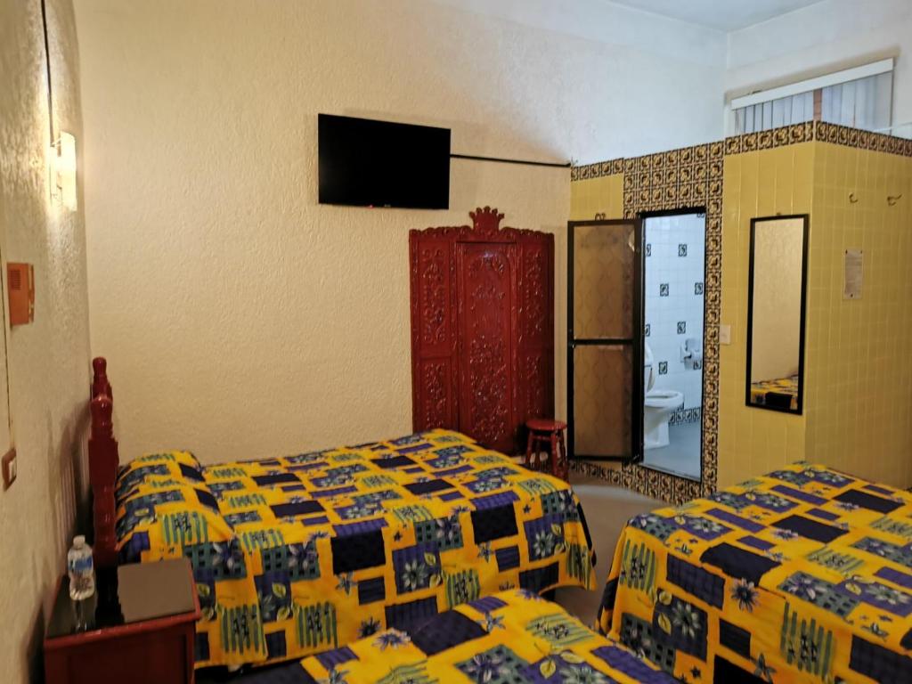 Postel nebo postele na pokoji v ubytování HOTEL LIMÓN