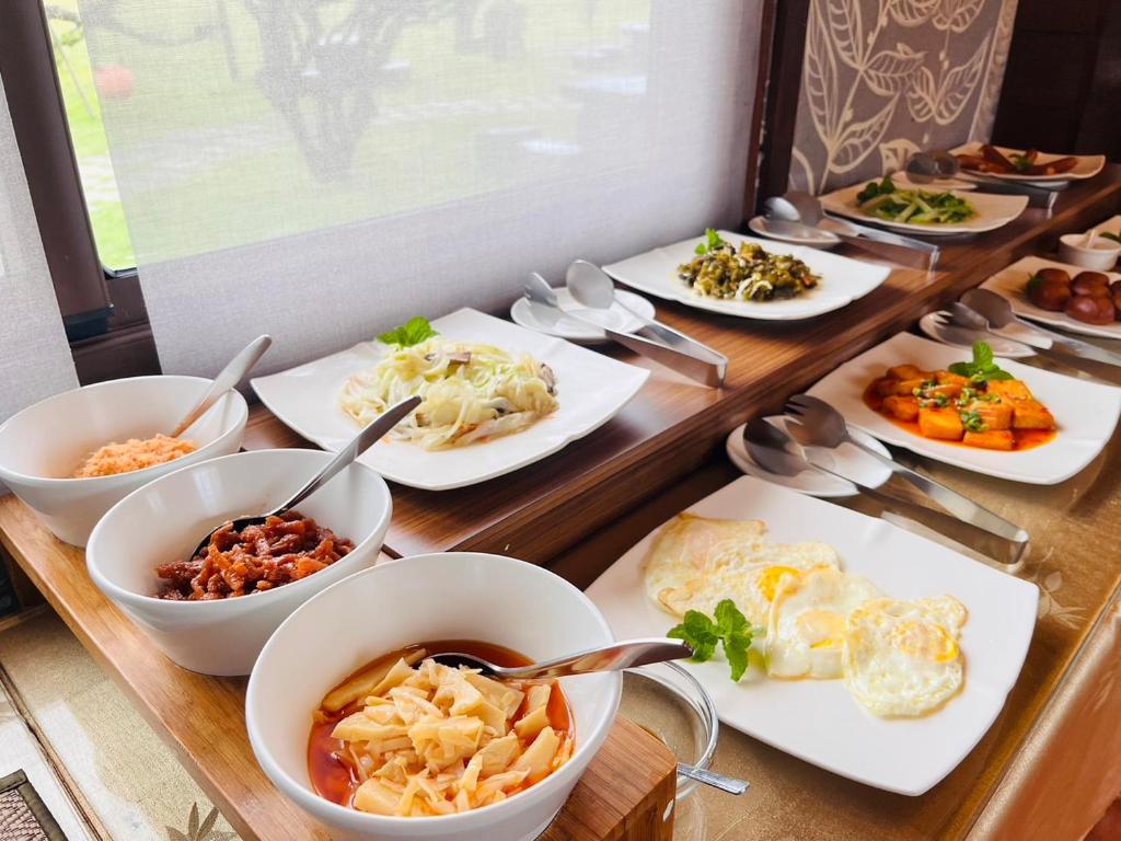 a buffet with plates of food on a table at Kenting Summerland Garden Resort in Eluan