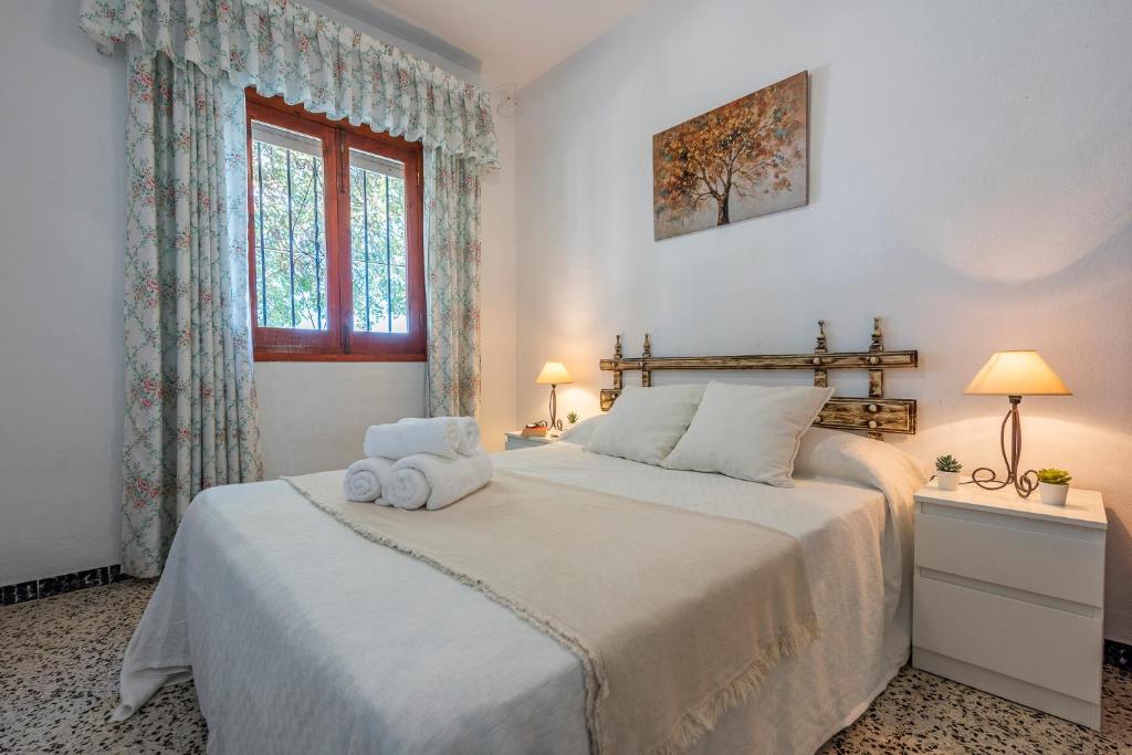 A bed or beds in a room at Los Algarrobos - Mountain and Relax near the beach