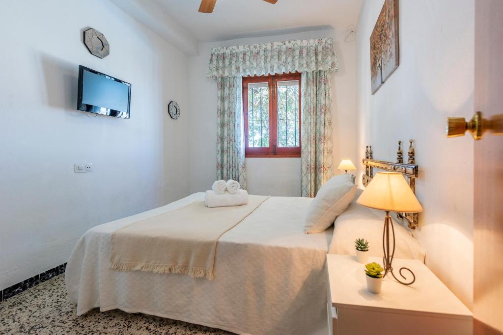 A bed or beds in a room at Los Algarrobos - Mountain and Relax near the beach