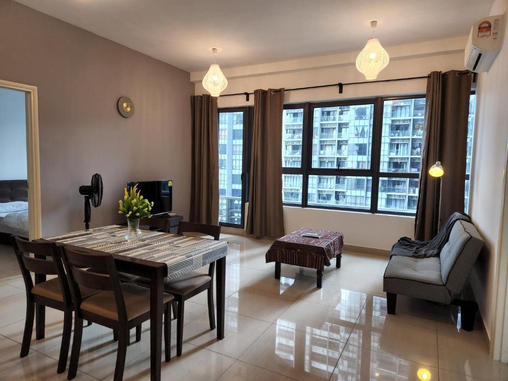 a living room with a dining room table and chairs at Cozy 2BR APT @Ampang Embassy Row in Kuala Lumpur