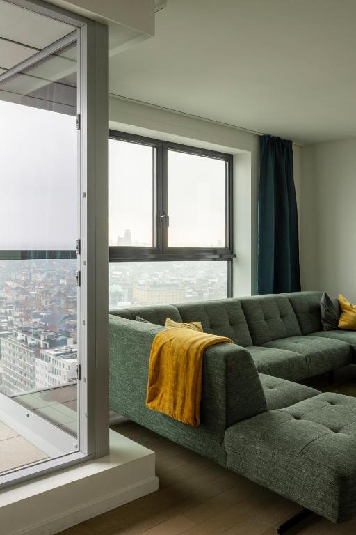 Area soggiorno di UNIEK appartement - mooiste en hoogste uitzicht op Antwerpen! - incl gratis parking