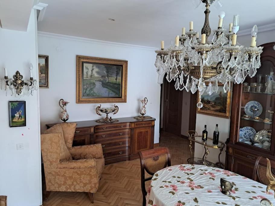 a dining room with a chandelier and a table at Piso amplio y acogedor in Madrid