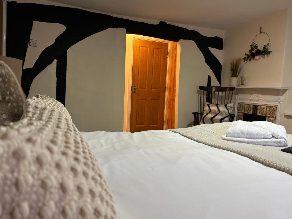 a bedroom with a large white bed with a wooden headboard at Bay Horse in York