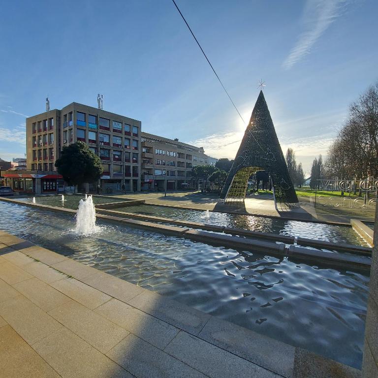 a fountain with a pyramid in the middle of a street at Alamedastudio in Vila do Conde