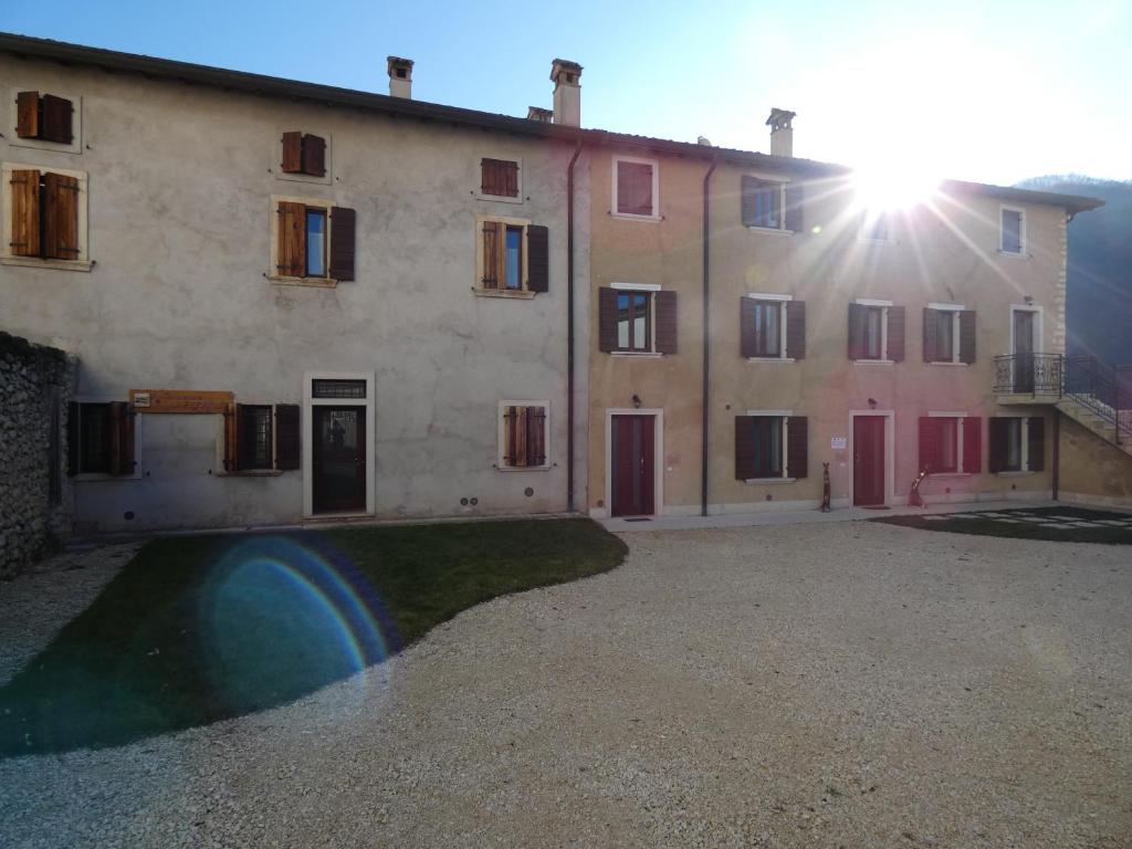 a large building with a pool in front of it at Alloggio turistico Corte Grisi in Badia Calavena