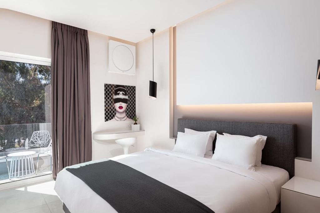 - une chambre avec un grand lit et une fenêtre dans l'établissement Mirada Hotel, à Athènes