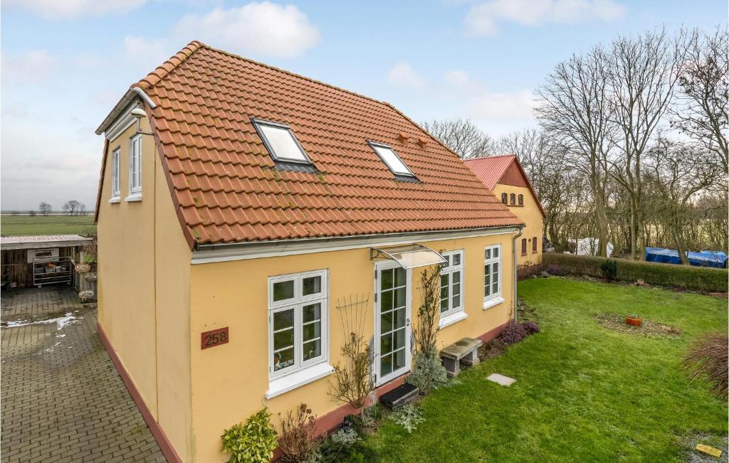 a small yellow house with a red roof at Nice Apartment In Haderslev With House Sea View in Haderslev