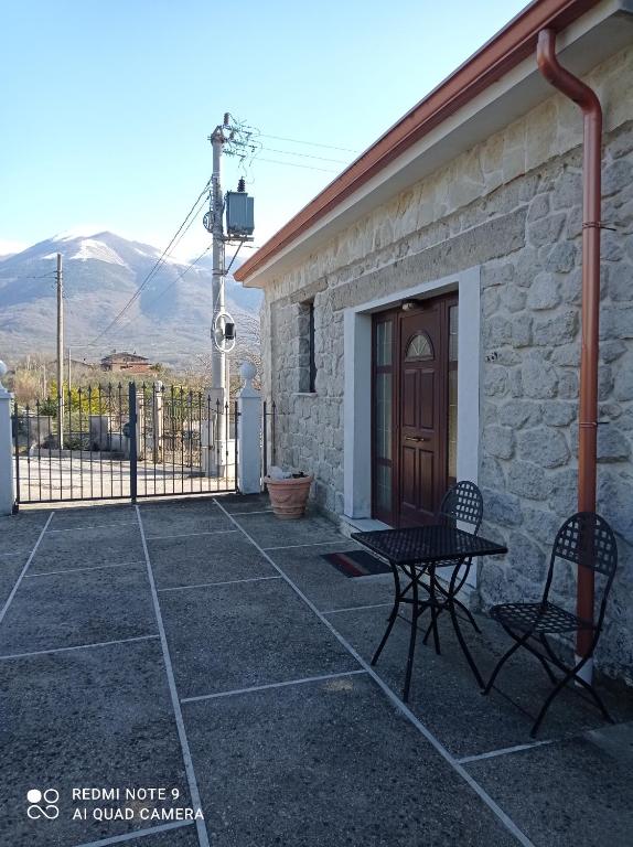 a patio with a table and chairs in front of a building at Lovely 1-Bed Apartment in Gallinaro in Gallinaro