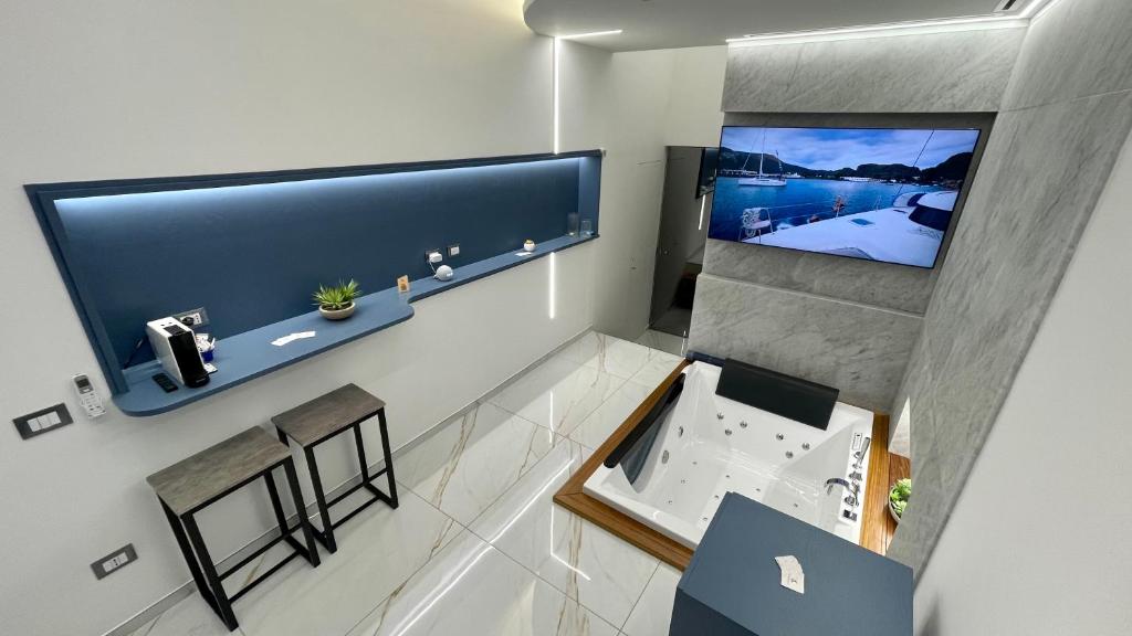 an overhead view of a bathroom with a flat screen tv at I Cappuccini Suite in Palermo