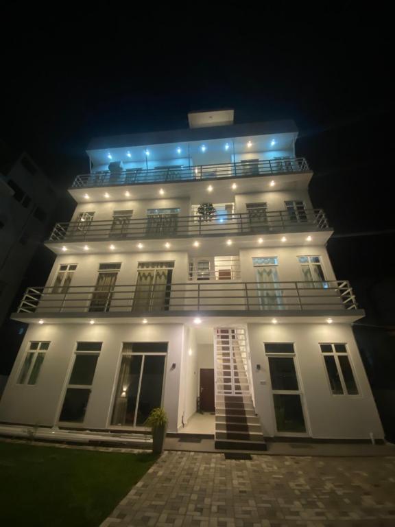 a white building with lights on it at night at Apartment near Colombo Airport in Katunayaka