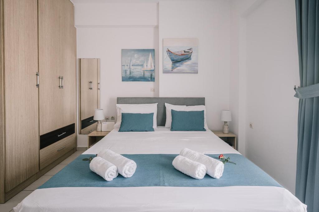 a bedroom with a large white bed with two pillows at Joy Apartment in Rethymno
