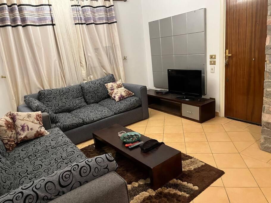 a living room with a couch and a tv at Sierra resort Nabq Bay in Sharm El Sheikh
