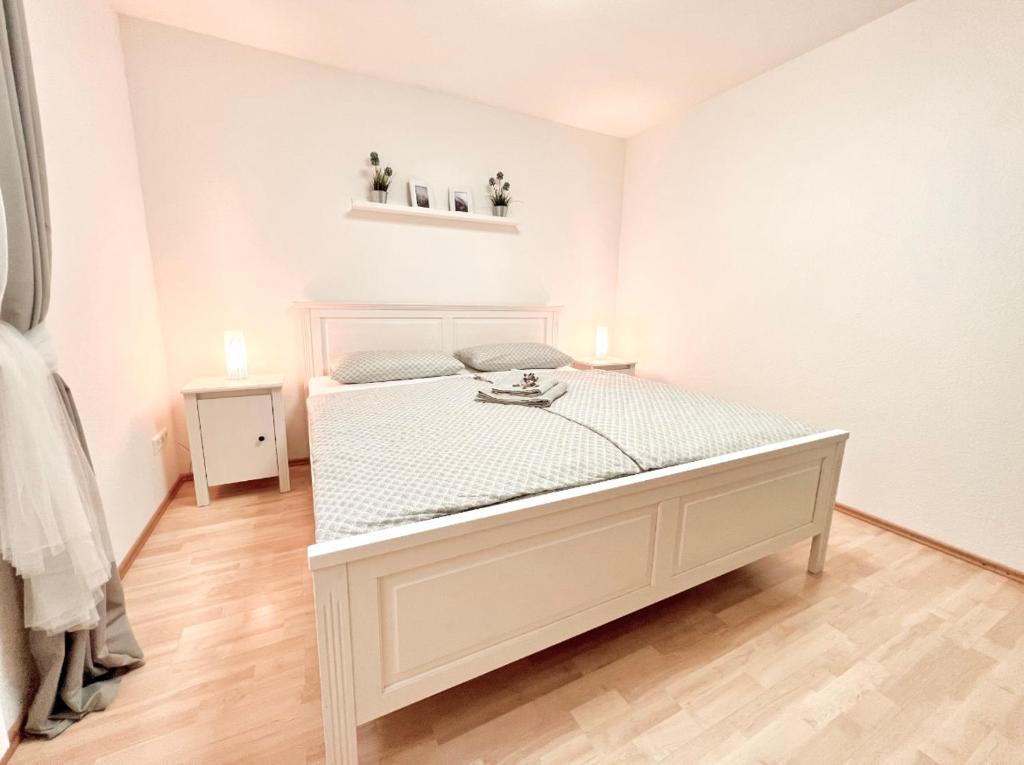 a large white bed in a white room at Black Forest Valley - Nähe Europa Park & Rulantica in Burgheim