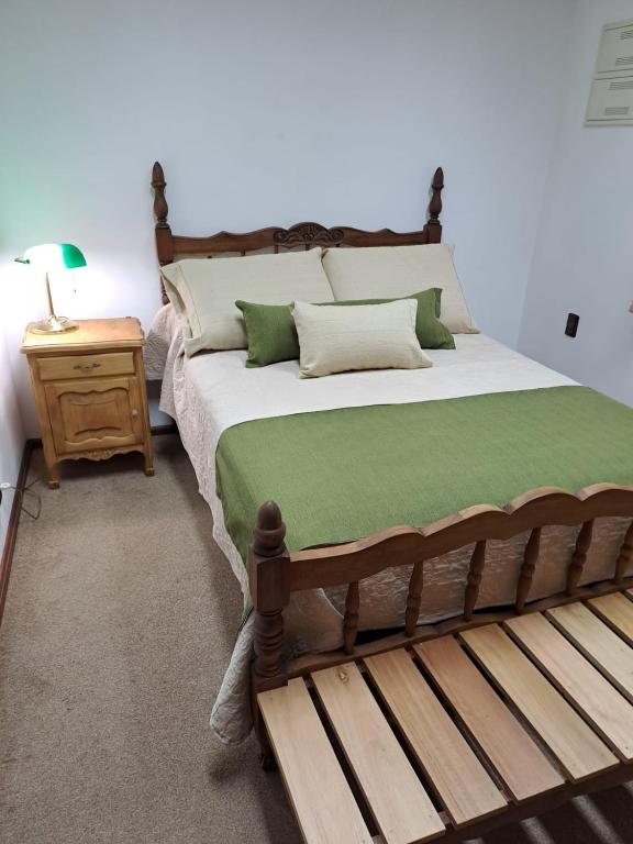a bedroom with a large bed and a wooden bench at Mykonos Centro Apartamento in Carmelo
