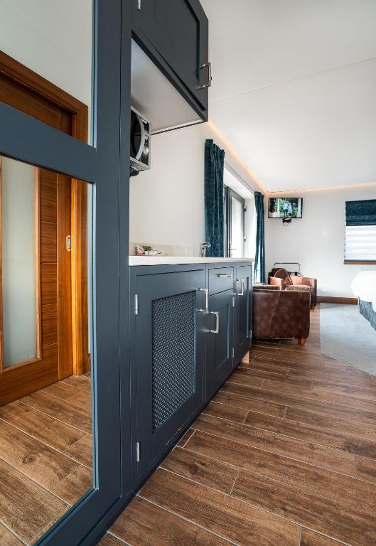 a living room with a door open to a living room at Antrim House Guest Rooms & Suites in Portrush