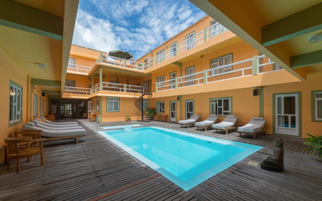 a swimming pool in the courtyard of a building at Wanna Studio Apartments in Pointe aux Cannoniers