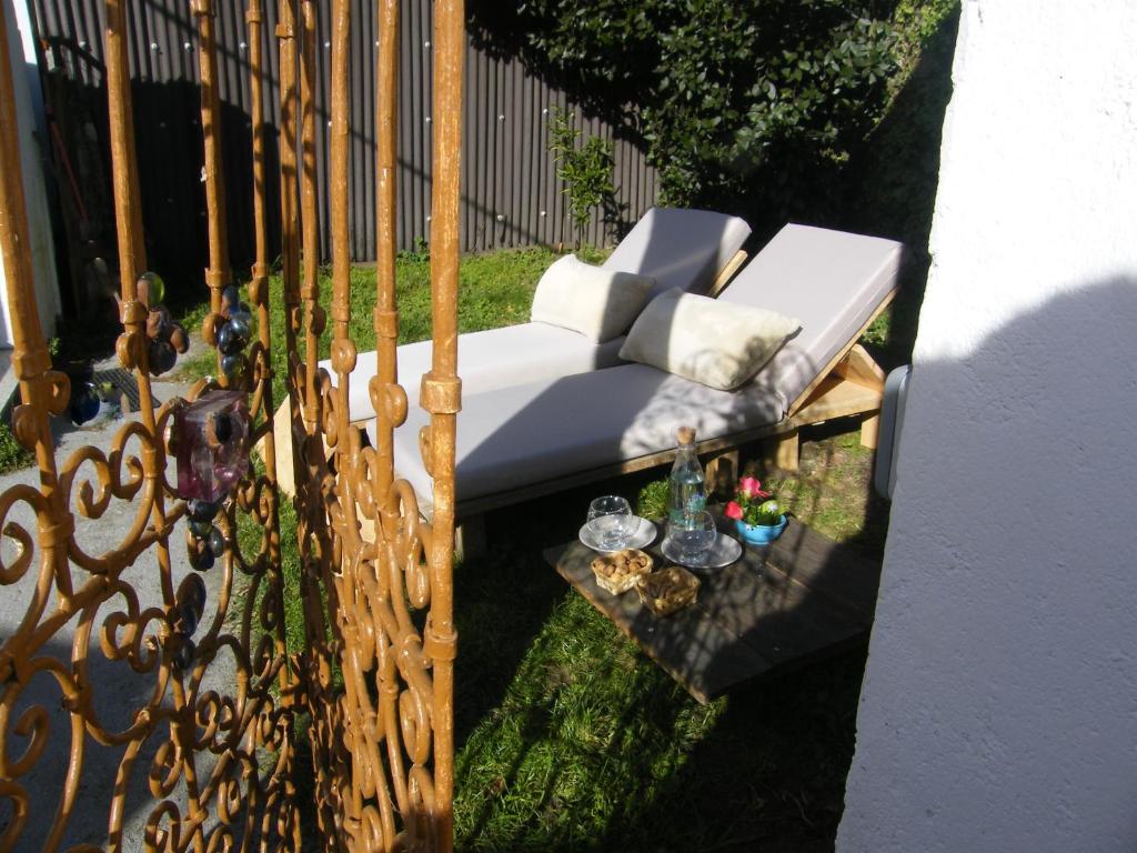 un sofá blanco en un patio junto a una valla en CASA MARGARITAS, en Ourense