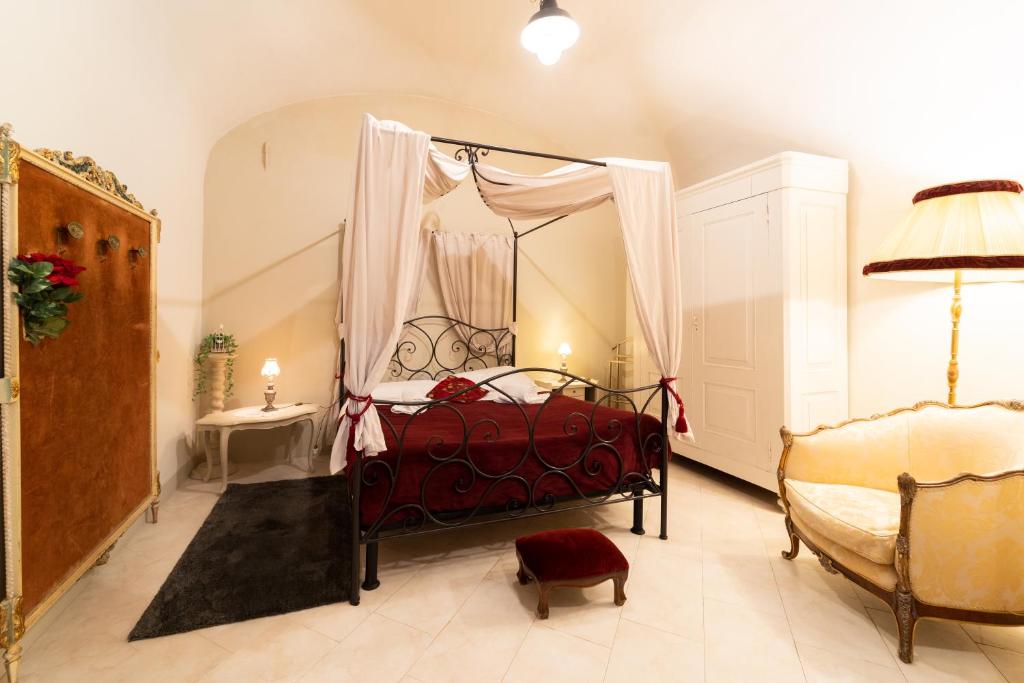 a bedroom with a red bed with a canopy at RESIDENZA ALDROVANDI SUITE in Bologna