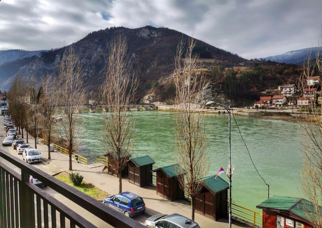 vistas a un río con coches aparcados en una calle en Apartment Mademoiselle, en Višegrad