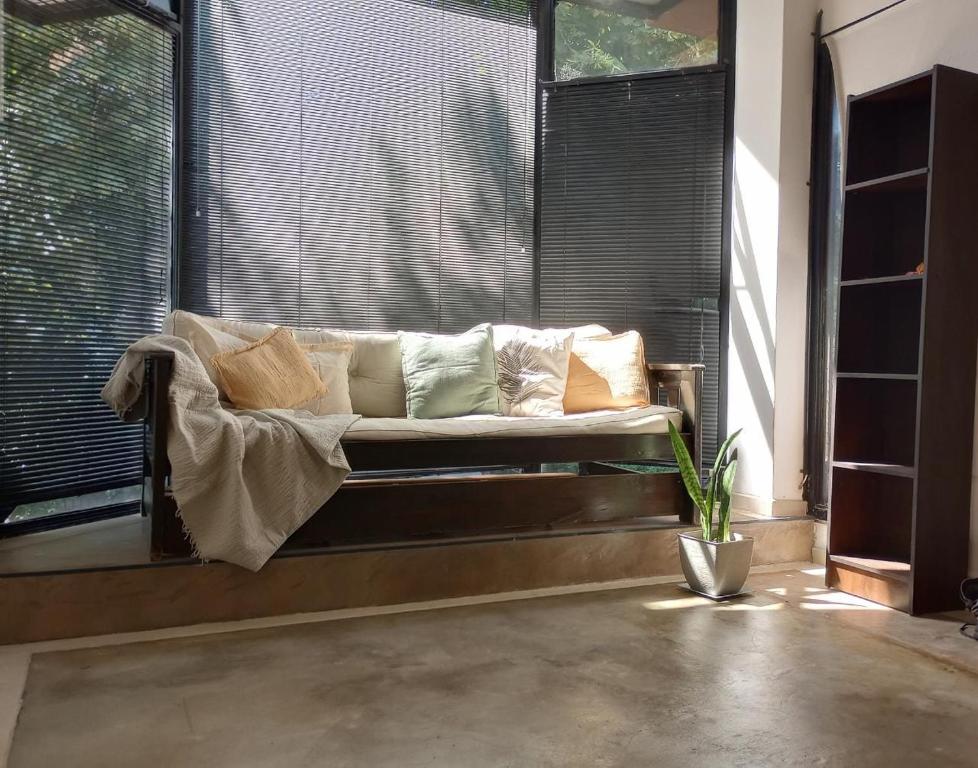 a couch sitting in front of a large window at Unique Loft with Wi-Fi & Netflix in Buenos Aires