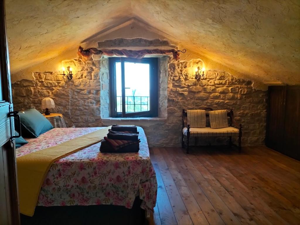 sypialnia z łóżkiem i oknem w budynku w obiekcie Old House w mieście Penna San Giovanni