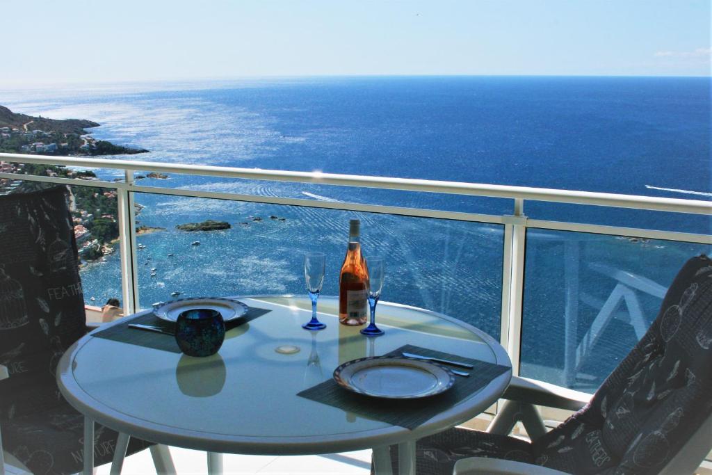 a table with a bottle of wine on a balcony at Mar Blau in Roses
