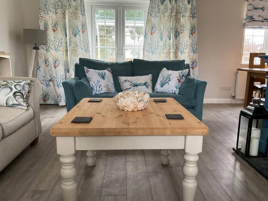 a living room with a table and a couch at Klara's House in West Mersea