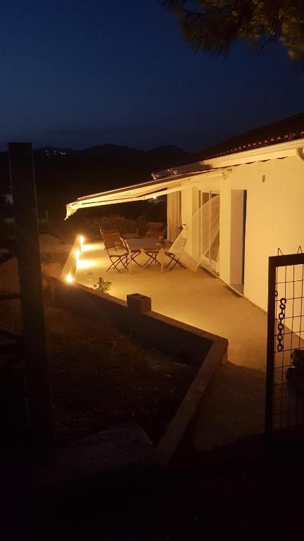 a house with a patio at night with lights at Country Cottage in Dafni, Limni in Limne