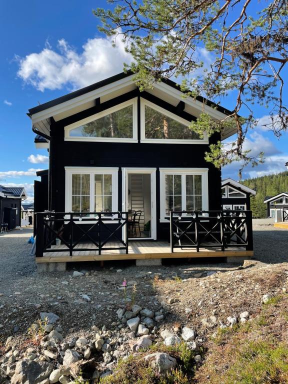 a black house with a large window at Stuga i Vemdalen in Vemdalen