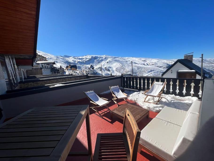 a balcony with two chairs and two laptops on it at LF LEVEL Sierra Nevada Duplex in Sierra Nevada
