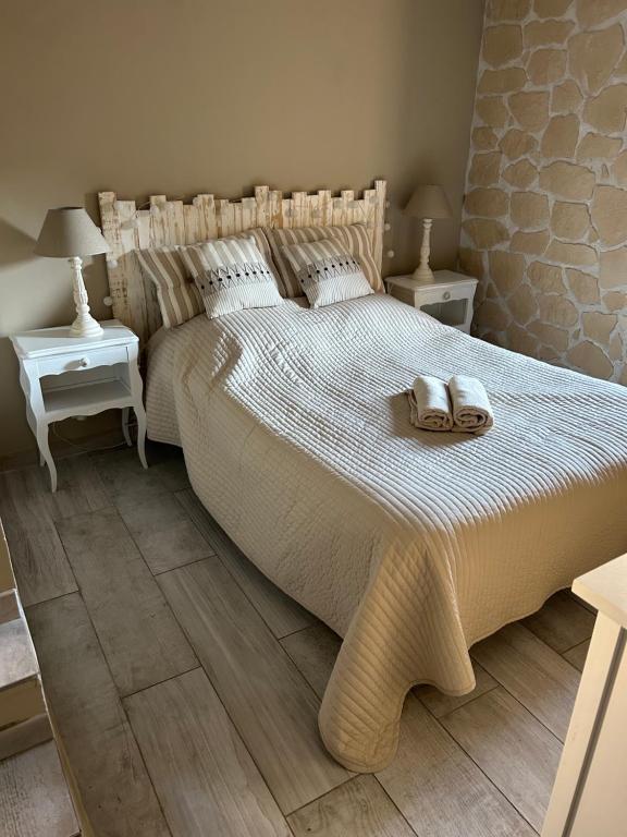 a bedroom with a large bed with two shoes on it at Location Bonnieux Provence in Bonnieux