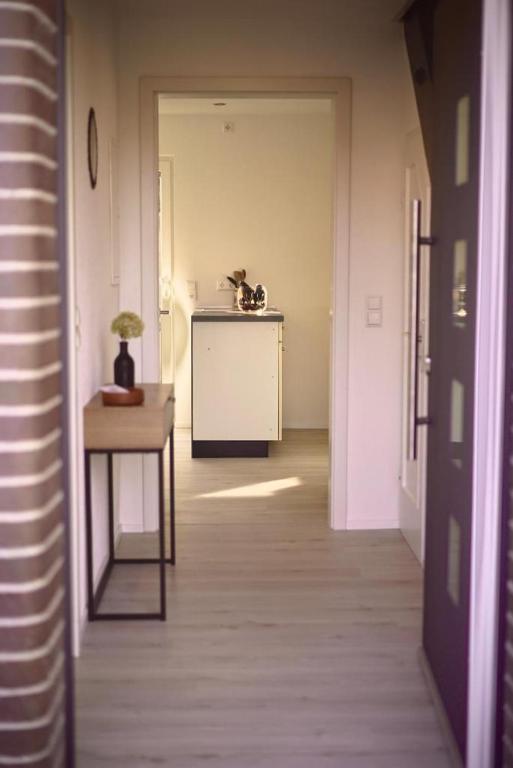 a hallway with a table and a room with a table sidx sidx sidx at Sehr beliebt! Ferienhaus zur Donau in Herbertingen