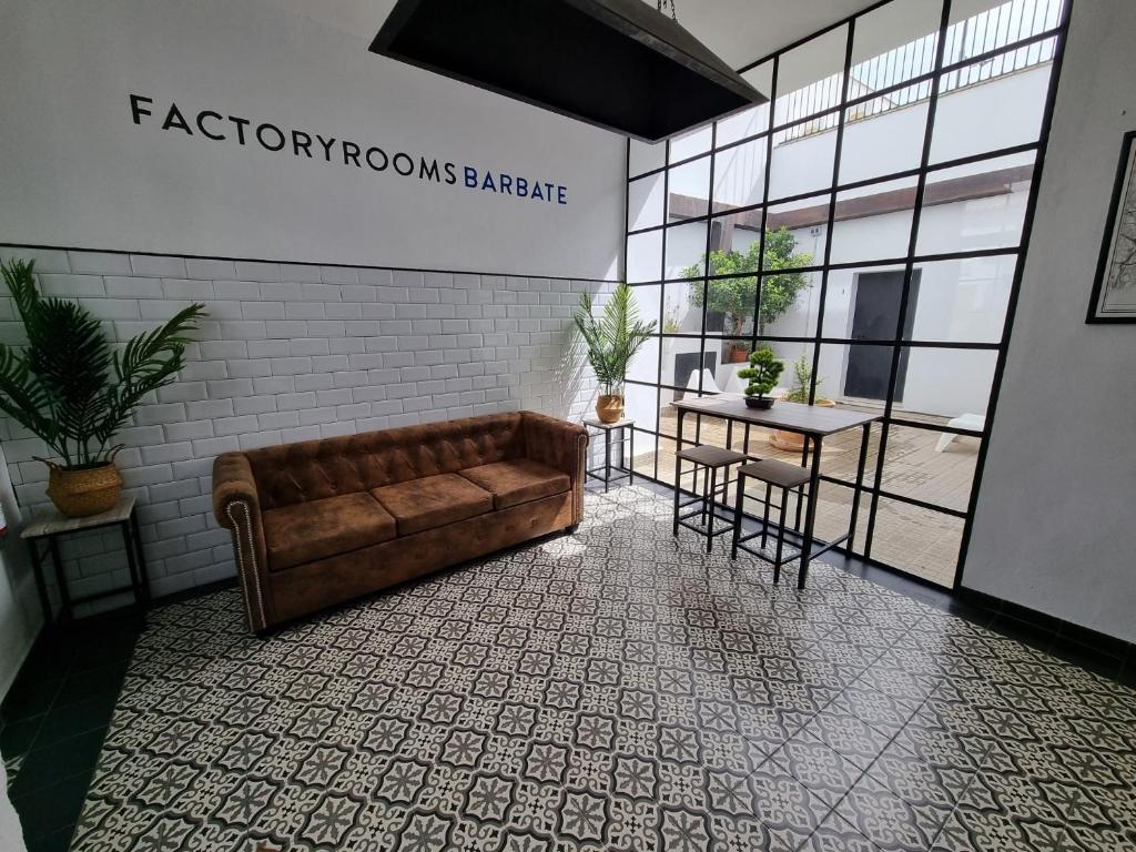 a living room with a couch and a table at Factory Rooms Barbate in Barbate