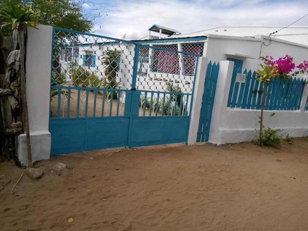 um portão azul em frente a uma casa em VILLA 3 DAUPHINS A 80 M DE LA PLAGE em Mahajanga