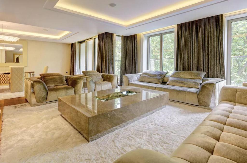 a living room with a couch and a coffee table at Luxurious flat with four bedrooms in London