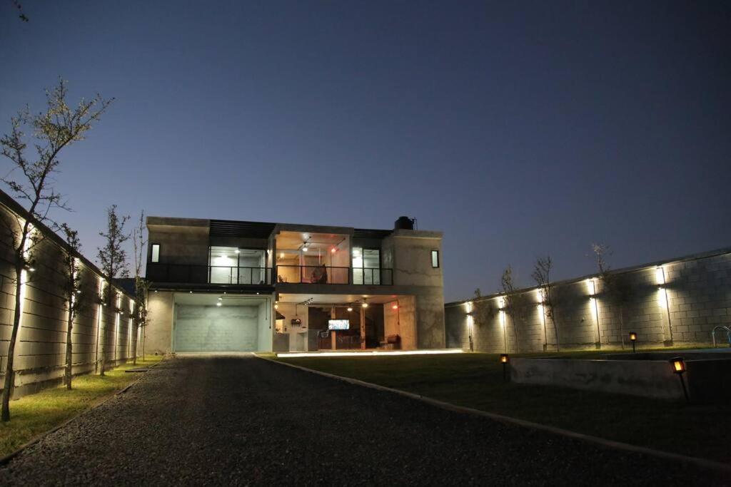 a large building with lights on it at night at Casa en Allende con alberca (Casa Guaname) 